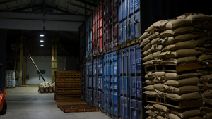 Coffee bags and shipping containers in coffee warehouse in Indonesia