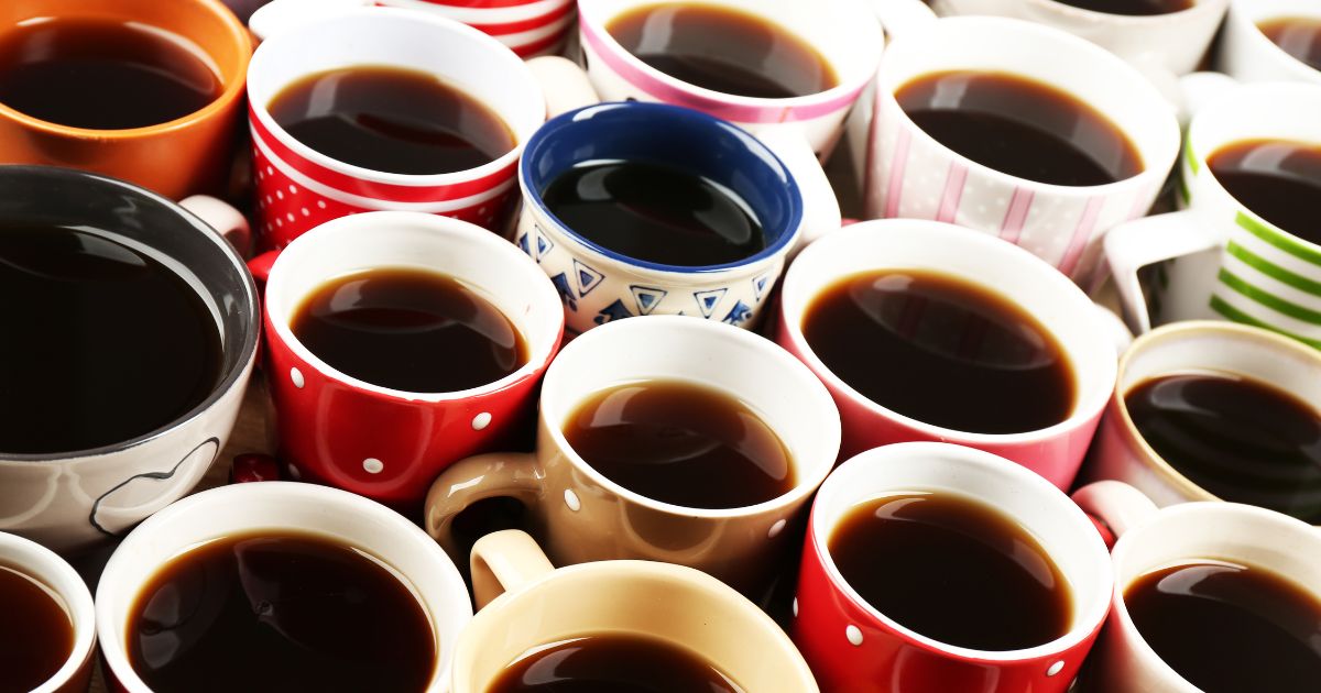 Many different color mugs of coffee grouped together 