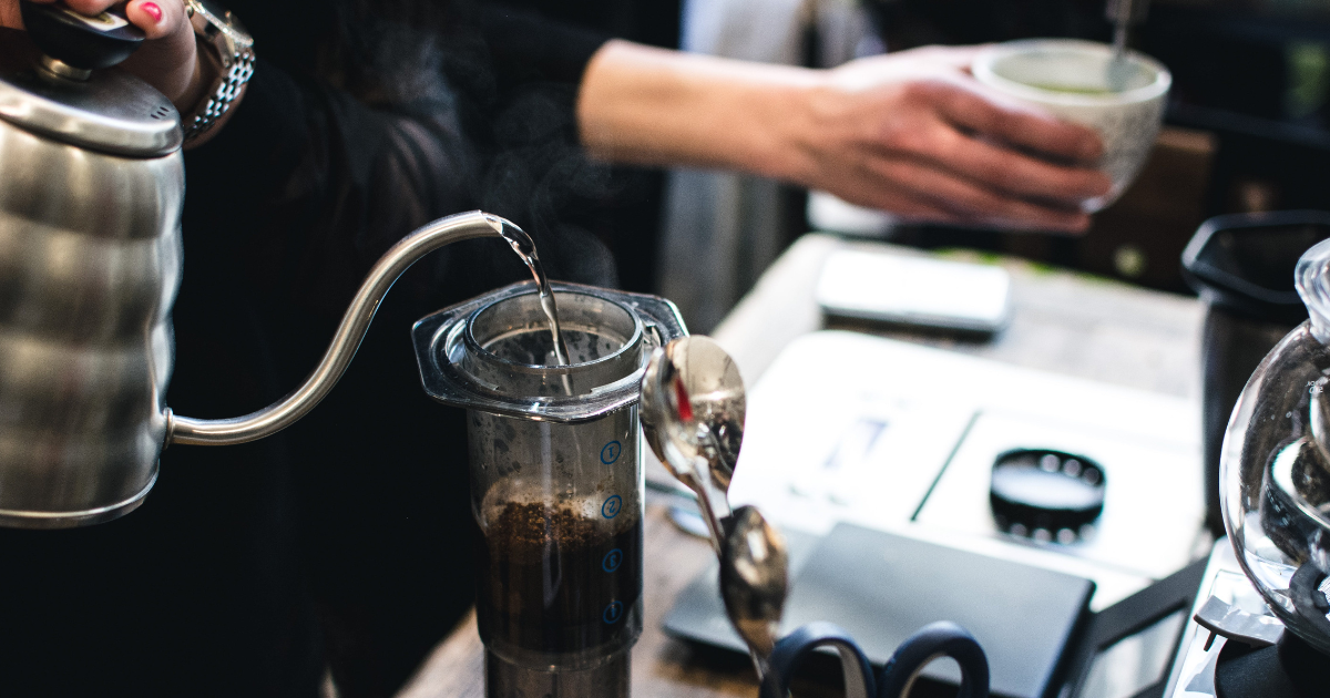 Using an Aeropress to brew an espresso in a coffee shop 