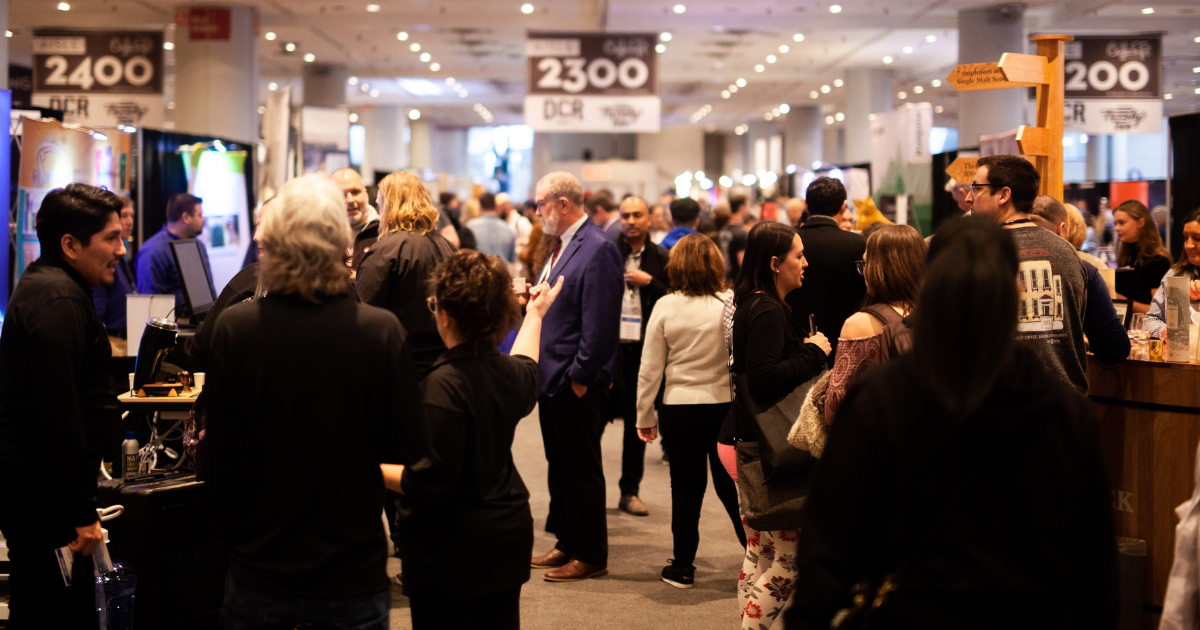 A crowd of people at Coffee Fest NY tradeshow aisle 