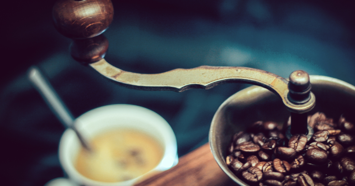 Manual coffee grinder | Pic by Tom Swinnen from Pexels - Genuine Origin Coffee Manual coffee grinder in foreground with mug of fresh coffee