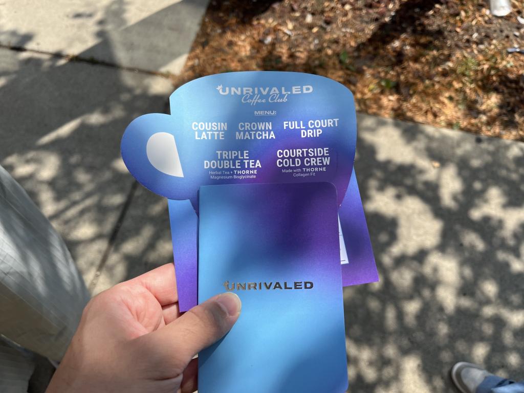 A blue and purple menu for the Unrivaled Coffee Club being held
